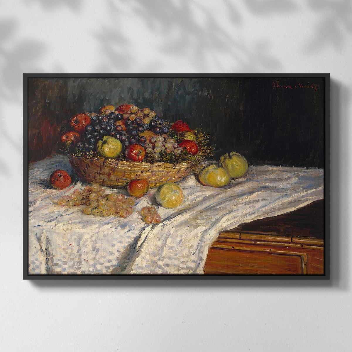Front view of Still Life with Apples and Grapes, 1880 by Claude Monet in a black floater framed canvas.