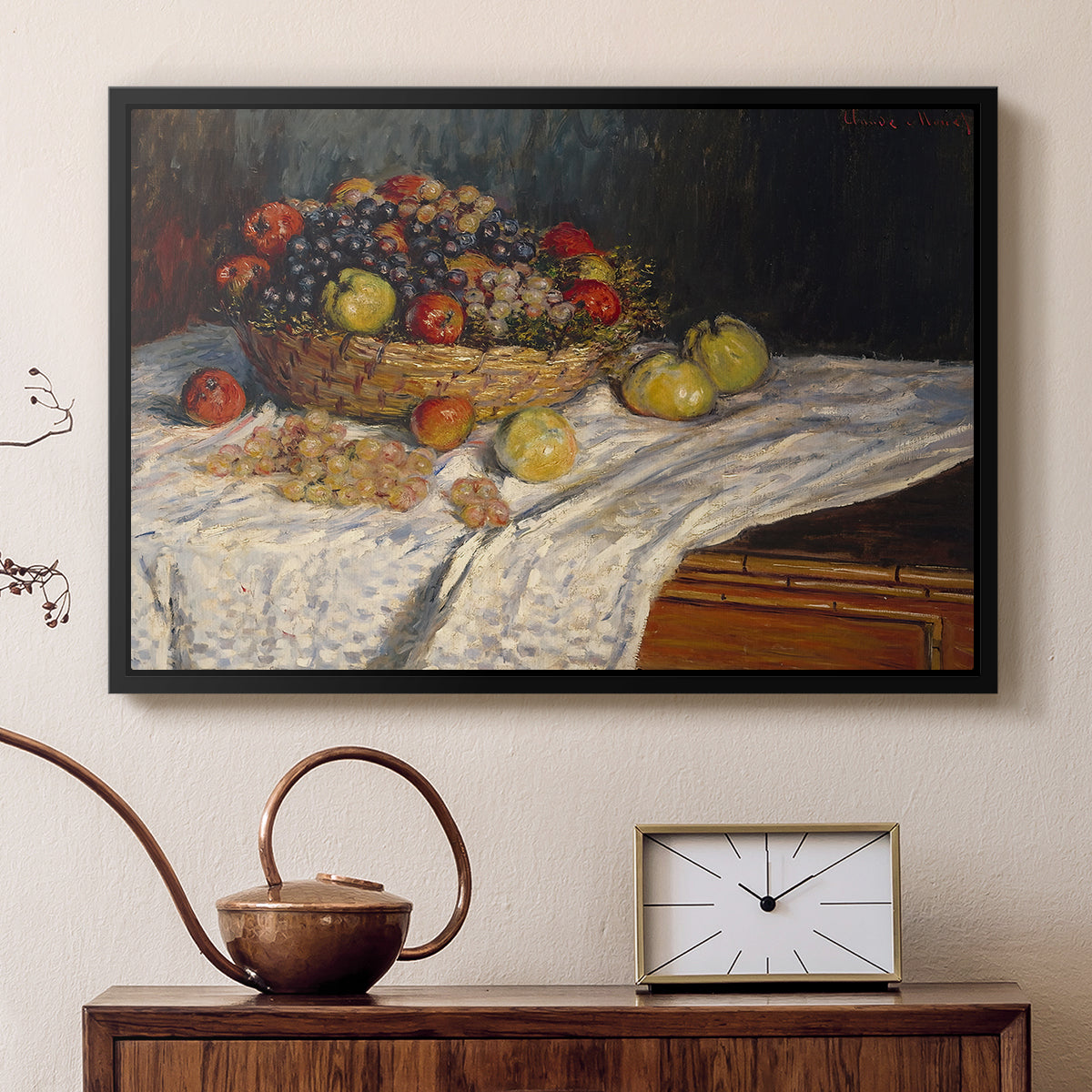 Black floater framed canvas featuring a close-up of apples and grapes in warm tones, displayed above a cabinet in a soft-toned living room.