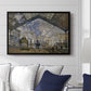 The Gare Saint-Lazare, 1877 by Claude Monet displayed above a sofa in a living room in a black floater frame, featuring an impressionist scene of trains and smoke inside busy railway station.