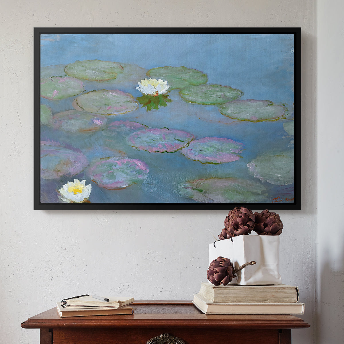 Black floater framed canvas featuring Water Lilies (Nymphéas), 1897-1899 by Claude Monet above an entryway table in a minimalist foyer.