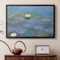 Black floater framed canvas featuring a tranquil water surface covered with blooming lilies, displayed above a cabinet in a soft-toned living room.