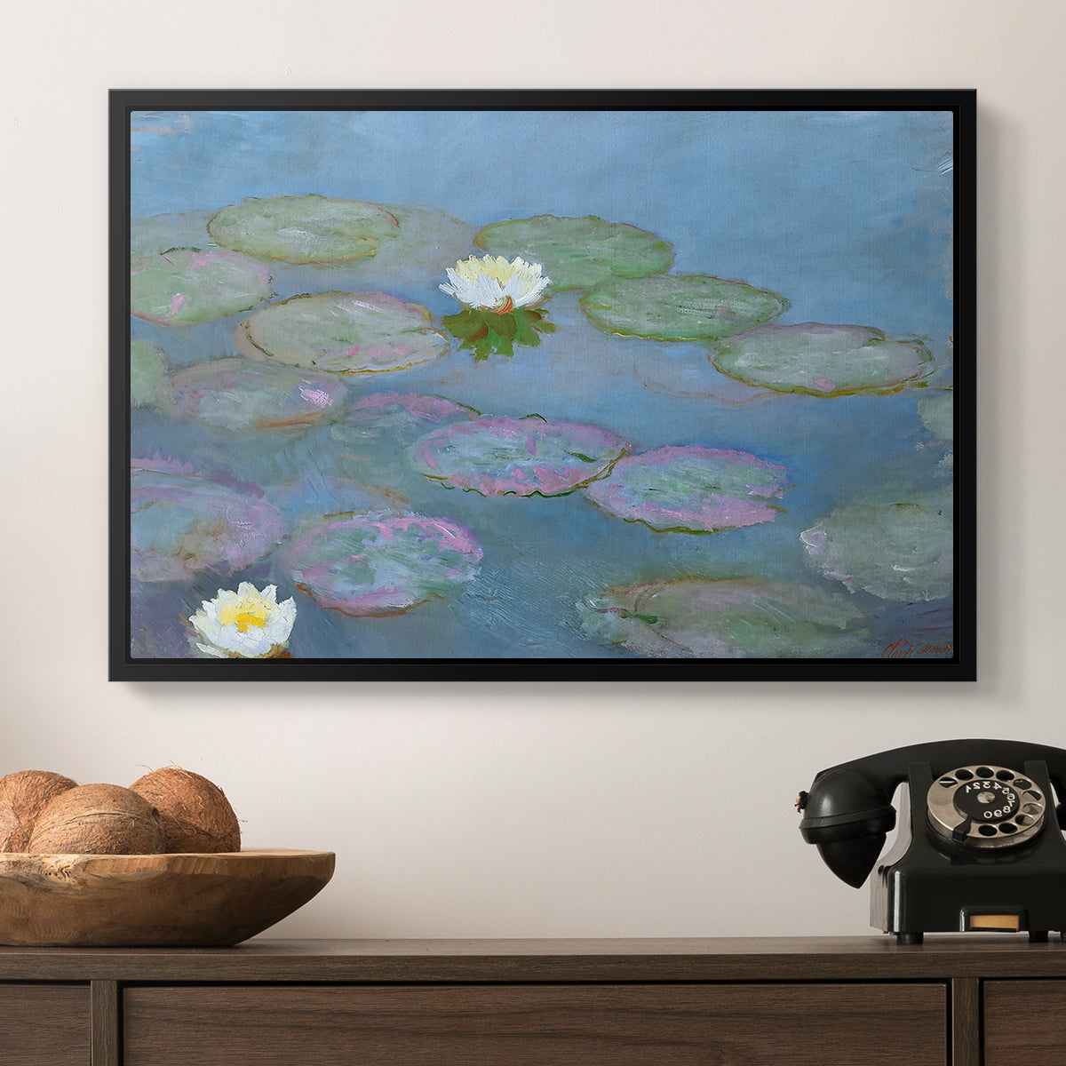 Water Lilies (Nymphéas), 1897-1899 by Claude Monet in a black floater framed canvas displayed above a console table in a hallway, featuring a close-up of aquatic plants in still water.