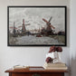 Black floater framed canvas featuring Windmills near Zaandam, 1871 by Claude Monet above an entryway table in a minimalist foyer.
