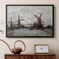 Black floater framed canvas featuring a countryside scene with traditional windmills and reflections, displayed above a cabinet in a soft-toned living room.