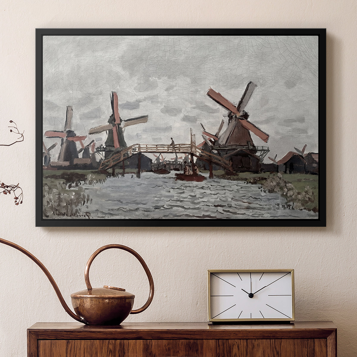 Black floater framed canvas featuring a countryside scene with traditional windmills and reflections, displayed above a cabinet in a soft-toned living room.
