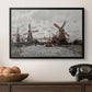 Windmills near Zaandam, 1871 by Claude Monet in a black floater framed canvas displayed above a console table in a hallway, featuring a landscape featuring windmills and low horizon sky.