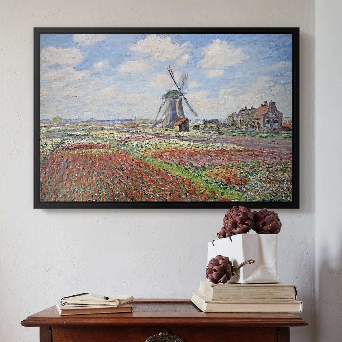 Black floater framed canvas featuring Tulip Fields with the Rijnsburg Windmill, 1886 by Claude Monet above an entryway table in a minimalist foyer.