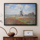 Black floater framed canvas featuring an impressionist field of blooming tulips under bright sky, displayed above a cabinet in a soft-toned living room.