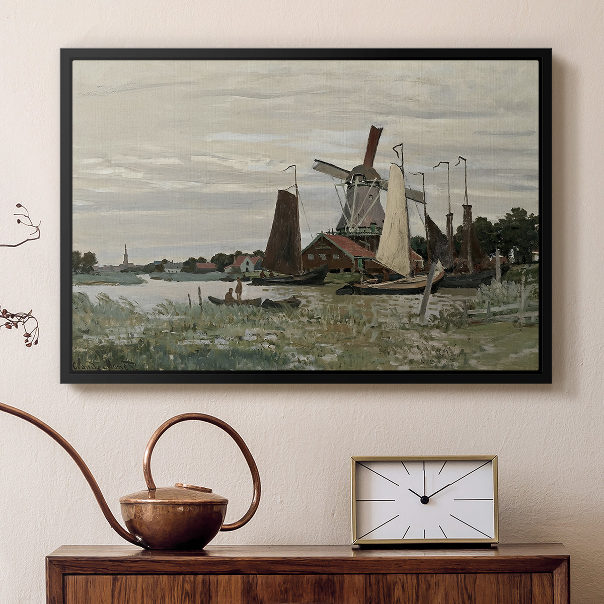 Black floater framed canvas featuring a rustic scene with windmill and reflections in water, displayed above a cabinet in a soft-toned living room.
