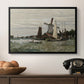 Windmill at Zaandam, 1871 by Claude Monet in a black floater framed canvas displayed above a console table in a hallway, featuring a countryside structure standing against open sky.