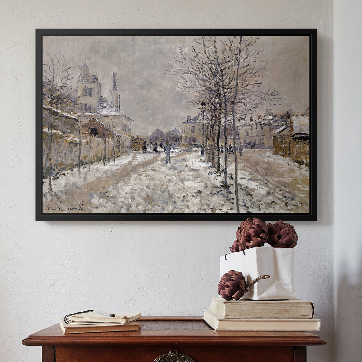 Black floater framed canvas featuring The Boulevard de Pontoise at Argenteuil, Snow Effect, 1875 by Claude Monet above an entryway table in a minimalist foyer.
