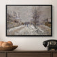 The Boulevard de Pontoise at Argenteuil, Snow Effect, 1875 by Claude Monet in a black floater framed canvas displayed above a console table in a hallway, featuring an urban winter landscape with muted tones and soft light.