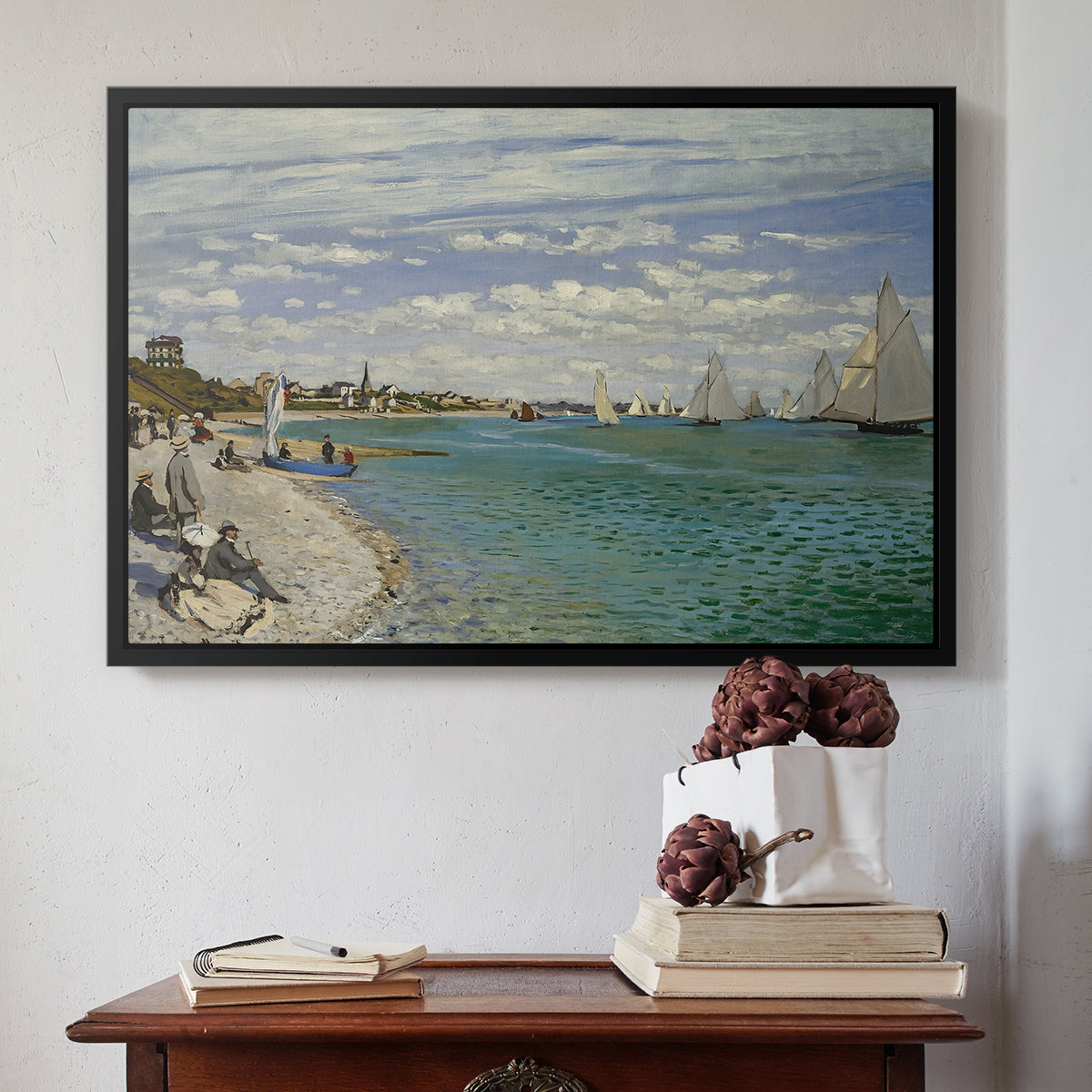 Black floater framed canvas featuring Regatta at Sainte-Adresse, 1867 by Claude Monet above an entryway table in a minimalist foyer.