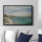 Regatta at Sainte-Adresse, 1867 by Claude Monet displayed above a sofa in a living room in a black floater frame, featuring a lively regatta scene with boats and people on beach.