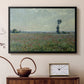 Black floater framed canvas featuring a rural meadow with scattered poppies and soft horizon, displayed above a cabinet in a soft-toned living room.