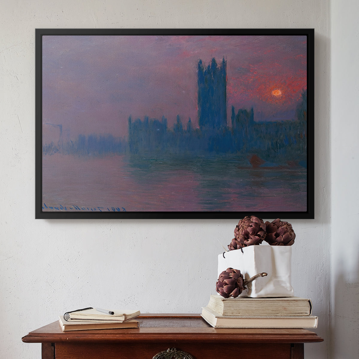 Black floater framed canvas featuring The Houses of Parliament, Sunset, 1903 by Claude Monet above an entryway table in a minimalist foyer.