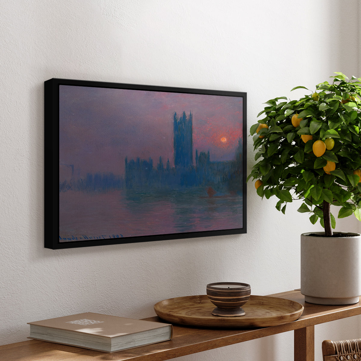 The Houses of Parliament, Sunset, 1903 by Claude Monet, presented in a black floater framed canvas featuring a silhouette of Parliament buildings against glowing sunset across river, displayed above a hallway console table.
