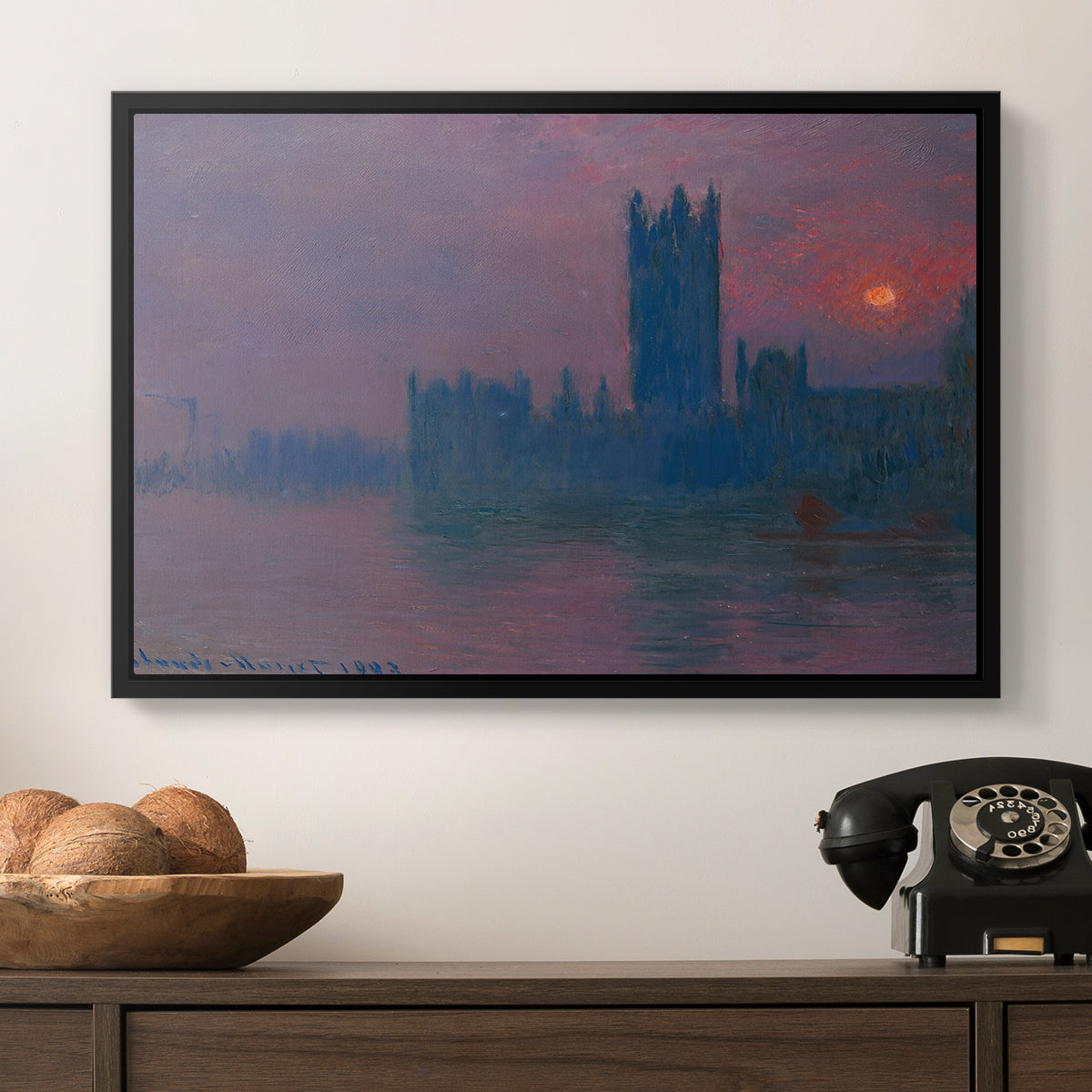 The Houses of Parliament, Sunset, 1903 by Claude Monet in a black floater framed canvas displayed above a console table in a hallway, featuring a dramatic skyline with reflections under colorful sky.