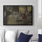 The Dance Class, c. 1873 by Edgar Degas displayed above a sofa in a living room in a black floater frame, featuring a rehearsal scene with dancers stretching and posing indoors.