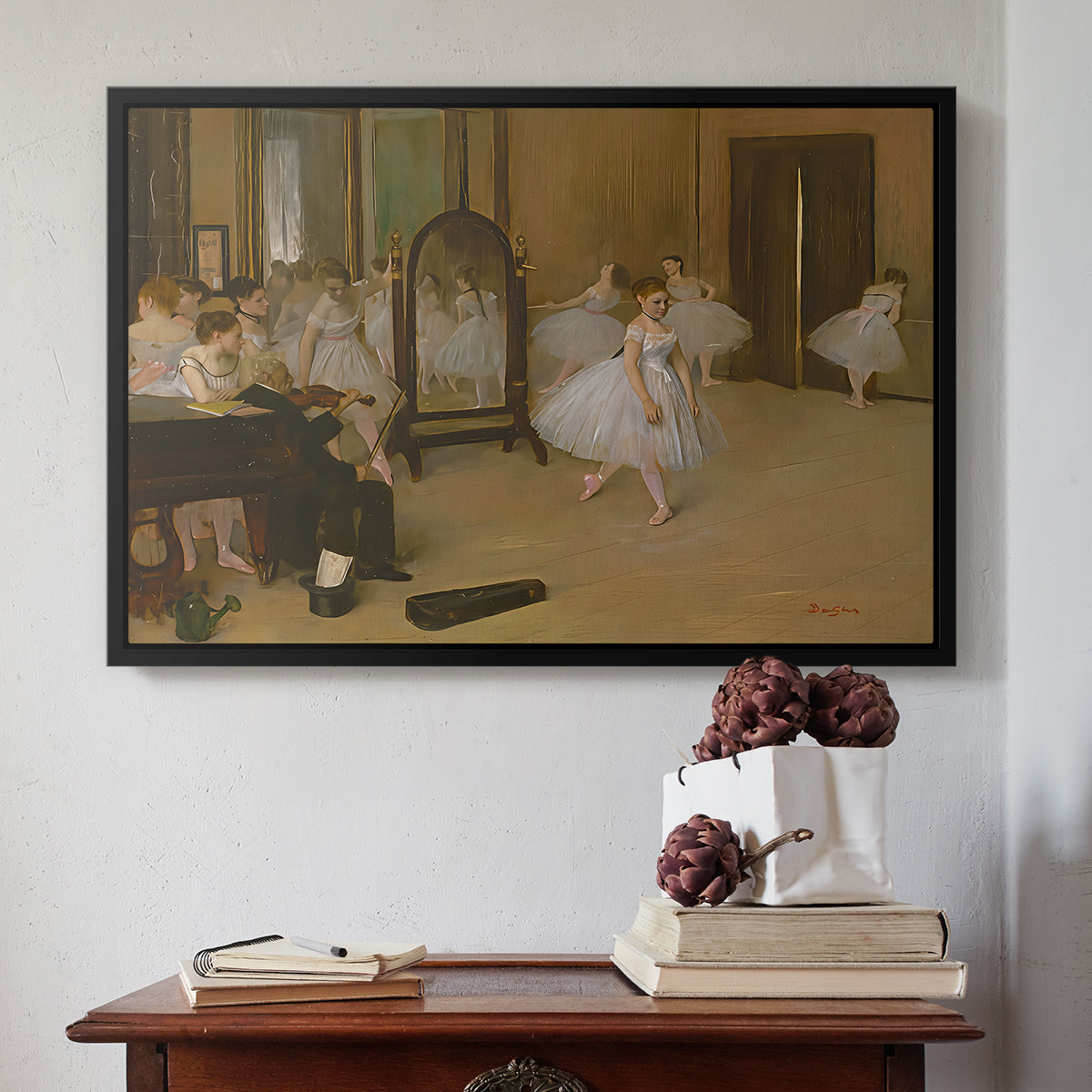 Black floater framed canvas featuring The Dancing Class, c. 1870 by Edgar Degas above an entryway table in a minimalist foyer.