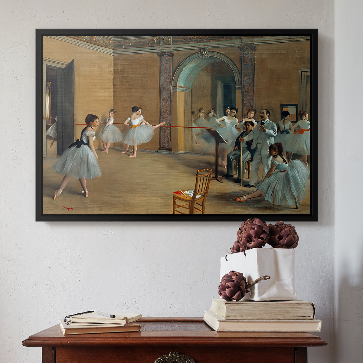 Black floater framed canvas featuring The Dance Foyer at the Opera on the Rue Le Peletier, 1872 by Edgar Degas above an entryway table in a minimalist foyer.