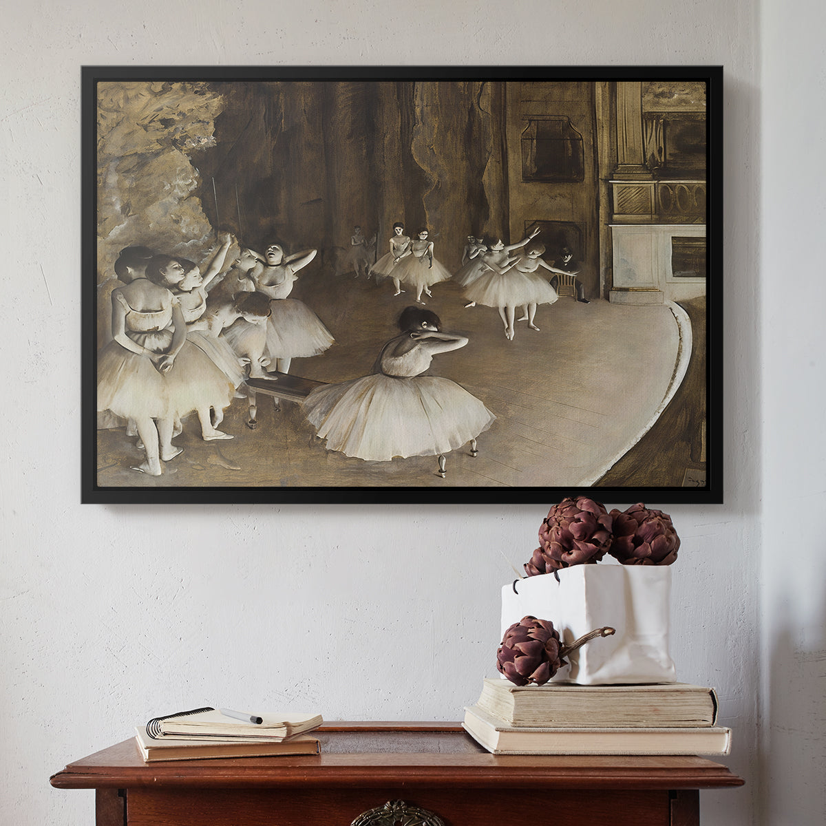 Black floater framed canvas featuring The Rehearsal of the Ballet Onstage, 1874 by Edgar Degas above an entryway table in a minimalist foyer.