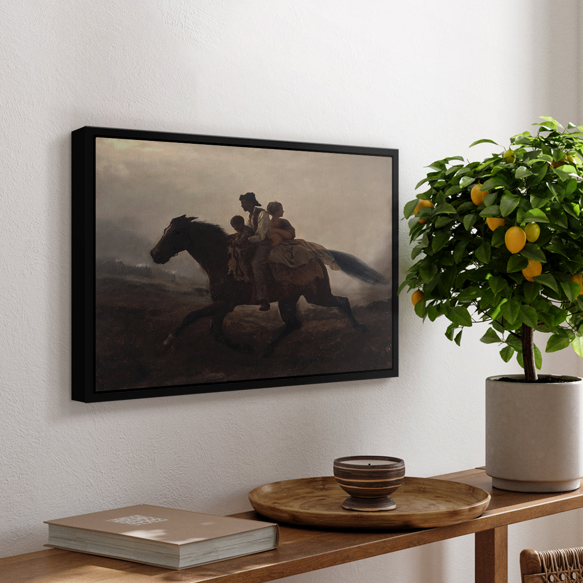 A Ride for Liberty – The Fugitive Slaves, c. 1862 by Eastman Johnson, presented in a black floater framed canvas featuring a family riding horseback through night escaping across landscape, displayed above a hallway console table.