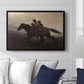A Ride for Liberty – The Fugitive Slaves, c. 1862 by Eastman Johnson displayed above a sofa in a living room in a black floater frame, featuring a dramatic scene of enslaved people fleeing on horseback in darkness.