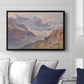 Odenwinklkees with the Johannisberg, 1902 by Edward Theodore Compton displayed above a sofa in a living room in a black floater frame, featuring a mountain scene with glacier stretching through rocky valley.