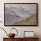 Black floater framed canvas featuring a realistic depiction of high-altitude snowy peaks, displayed above a cabinet in a soft-toned living room.