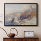 Black floater framed canvas featuring a panoramic alpine view with snow and rocky cliffs, displayed above a cabinet in a soft-toned living room.