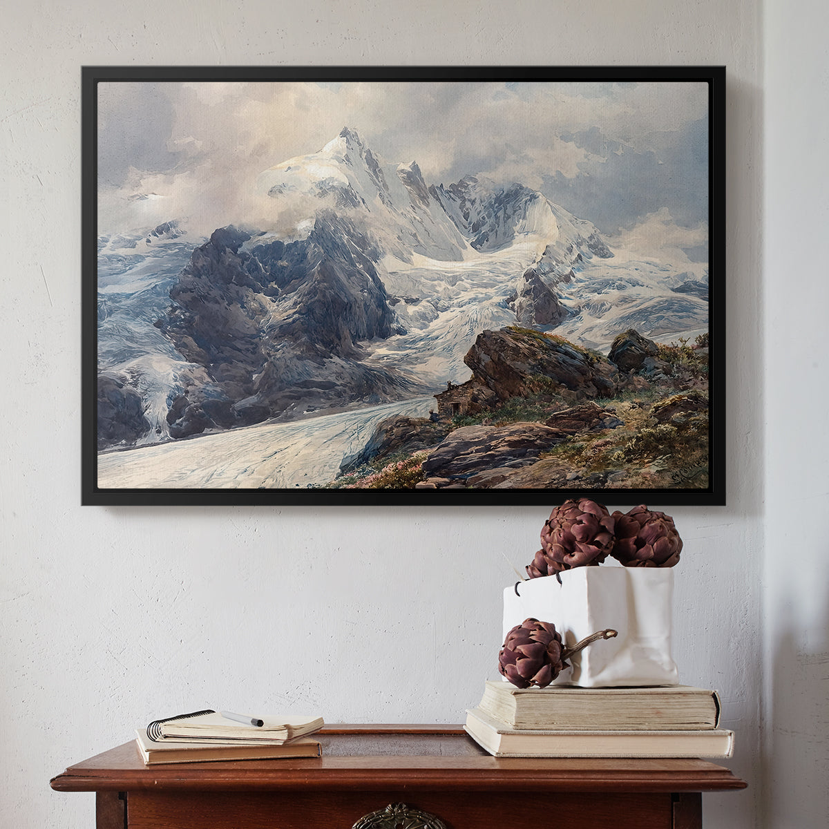 Black floater framed canvas featuring The Grossglockner, 1880 by Edward Theodore Compton above an entryway table in a minimalist foyer.
