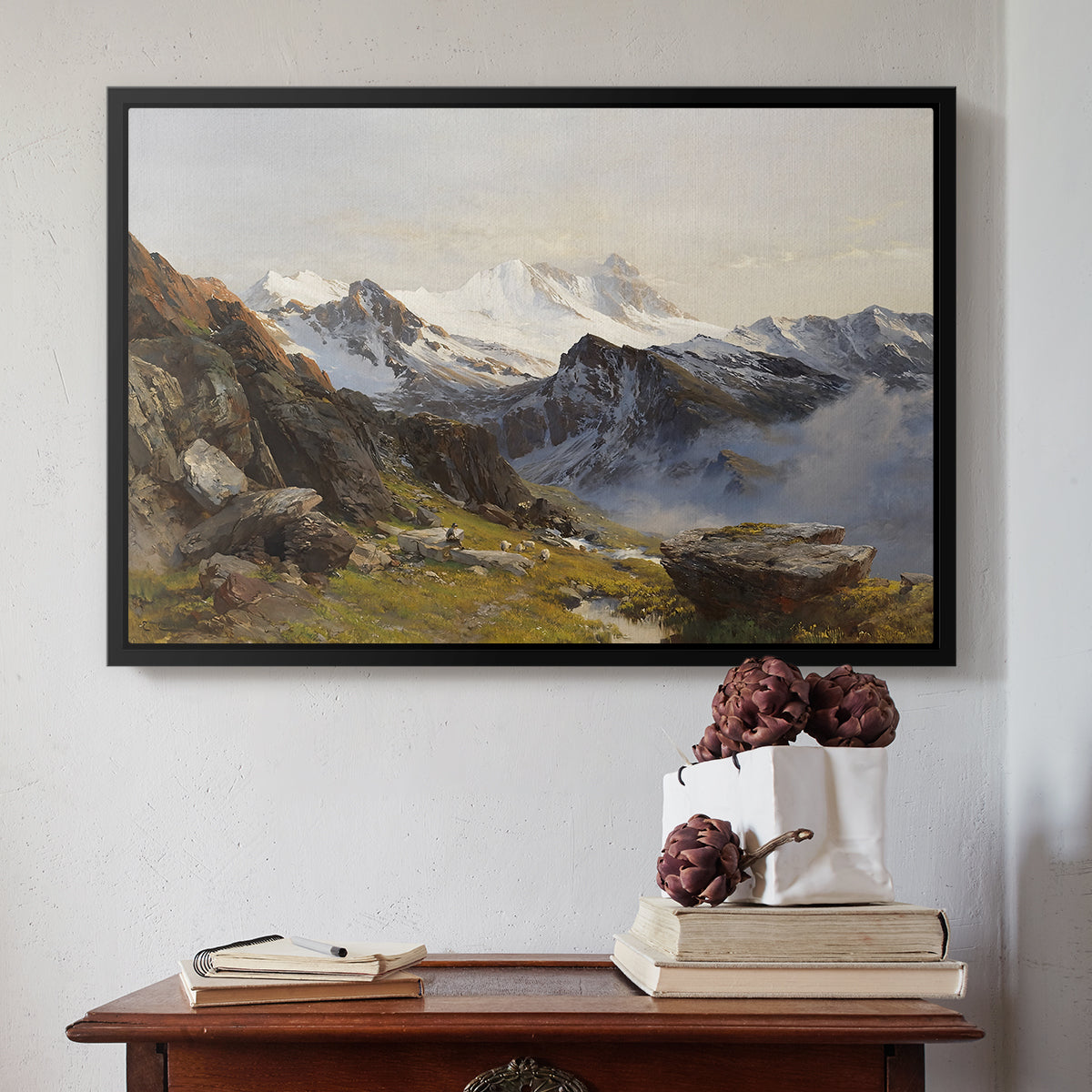 Black floater framed canvas featuring The Großglockner from the Prager Hut, 1890 by Edward Theodore Compton above an entryway table in a minimalist foyer.