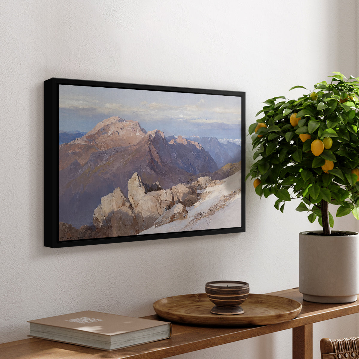 Hoher Göll from Watzmann-Hocheck, 1919 by Edward Theodore Compton, presented in a black floater framed canvas featuring a distant mountain peak viewed from elevated ridge with sweeping landscape, displayed above a hallway console table.