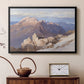 Black floater framed canvas featuring a high vantage point overlooking rugged mountain terrain, displayed above a cabinet in a soft-toned living room.