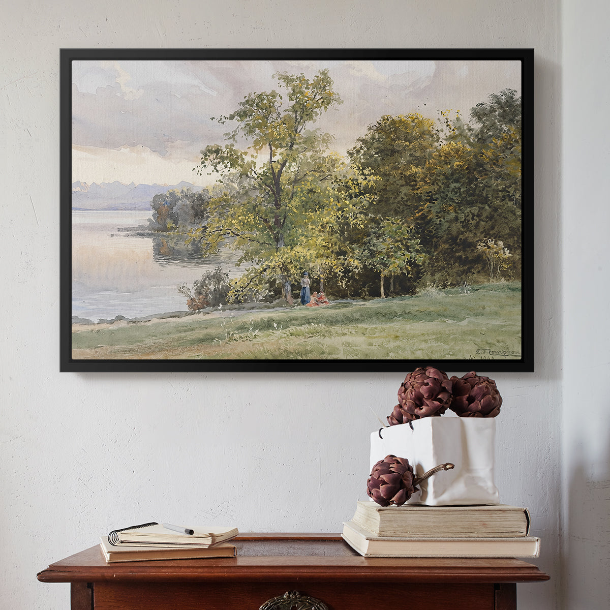 Black floater framed canvas featuring Landscape at Lake Starnberg, 1890 by Edward Theodore Compton above an entryway table in a minimalist foyer.