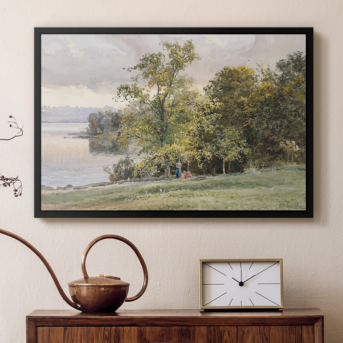 Black floater framed canvas featuring a natural setting with water, trees, and open sky, displayed above a cabinet in a soft-toned living room.