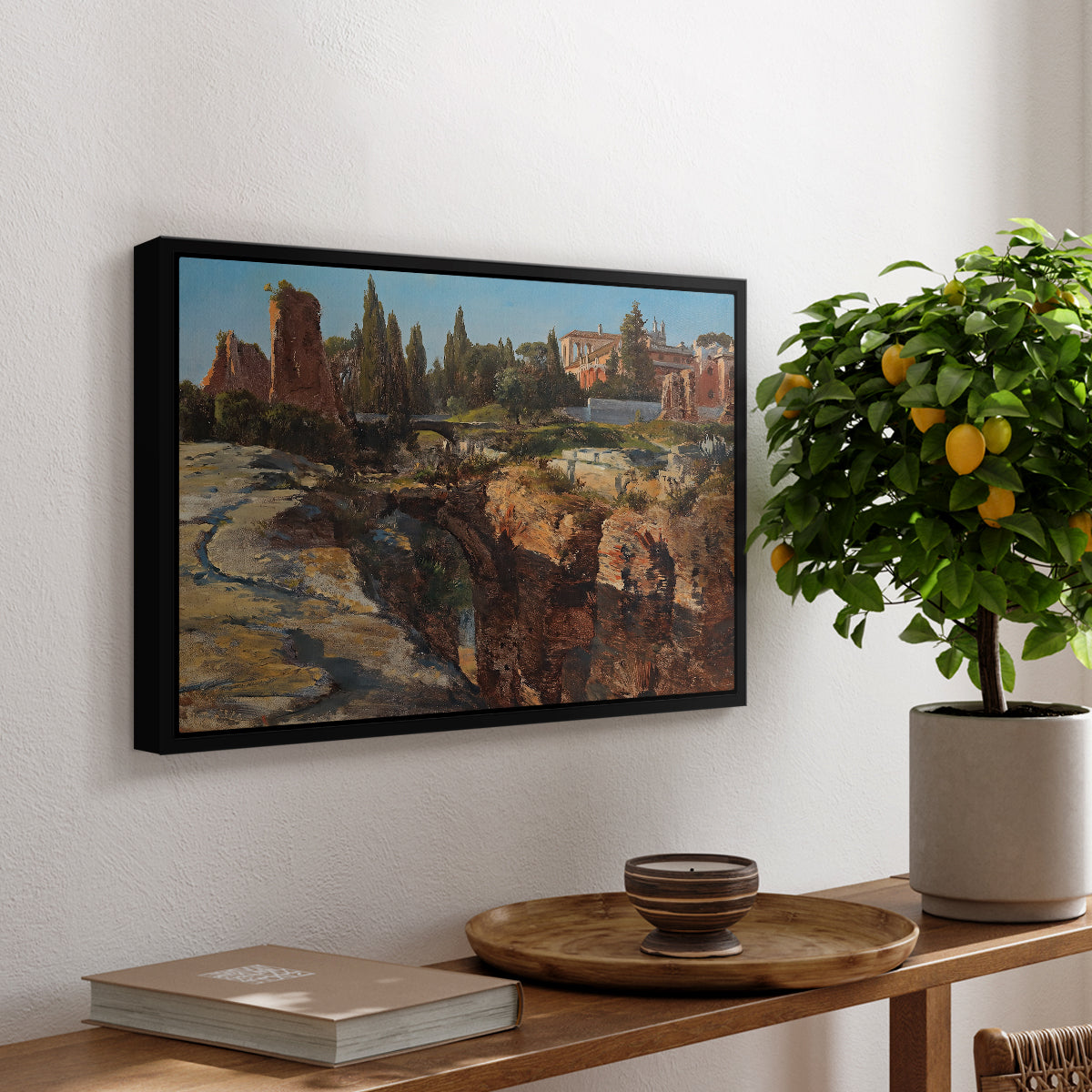Palatine in Rome, c. 1921 by Edward Theodore Compton, presented in a black floater framed canvas featuring historic Roman ruins and buildings set within warm landscape, displayed above a hallway console table.