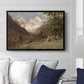 Landscape in the Caucasus, c. 1921 by Edward Theodore Compton displayed above a sofa in a living room in a black floater frame, featuring an expansive view of Caucasus mountains under open sky.