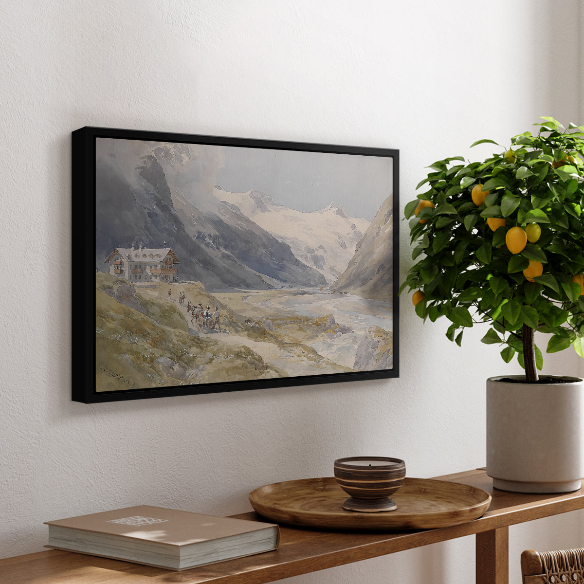 Shepherds (Pasterze), c. 1921 by Edward Theodore Compton, presented in a black floater framed canvas featuring a small group of shepherds in alpine landscape with grazing animals, displayed above a hallway console table.