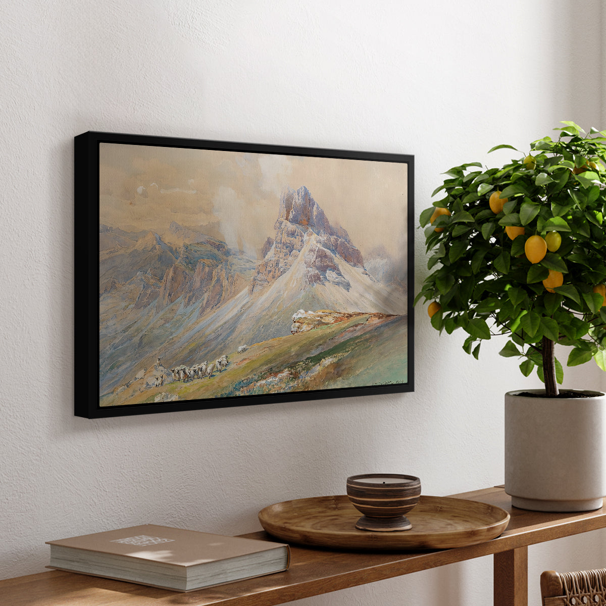 From the Dolomites, 1904 by Edward Theodore Compton, presented in a black floater framed canvas featuring dramatic Dolomite mountain peaks rising above rugged terrain, displayed above a hallway console table.