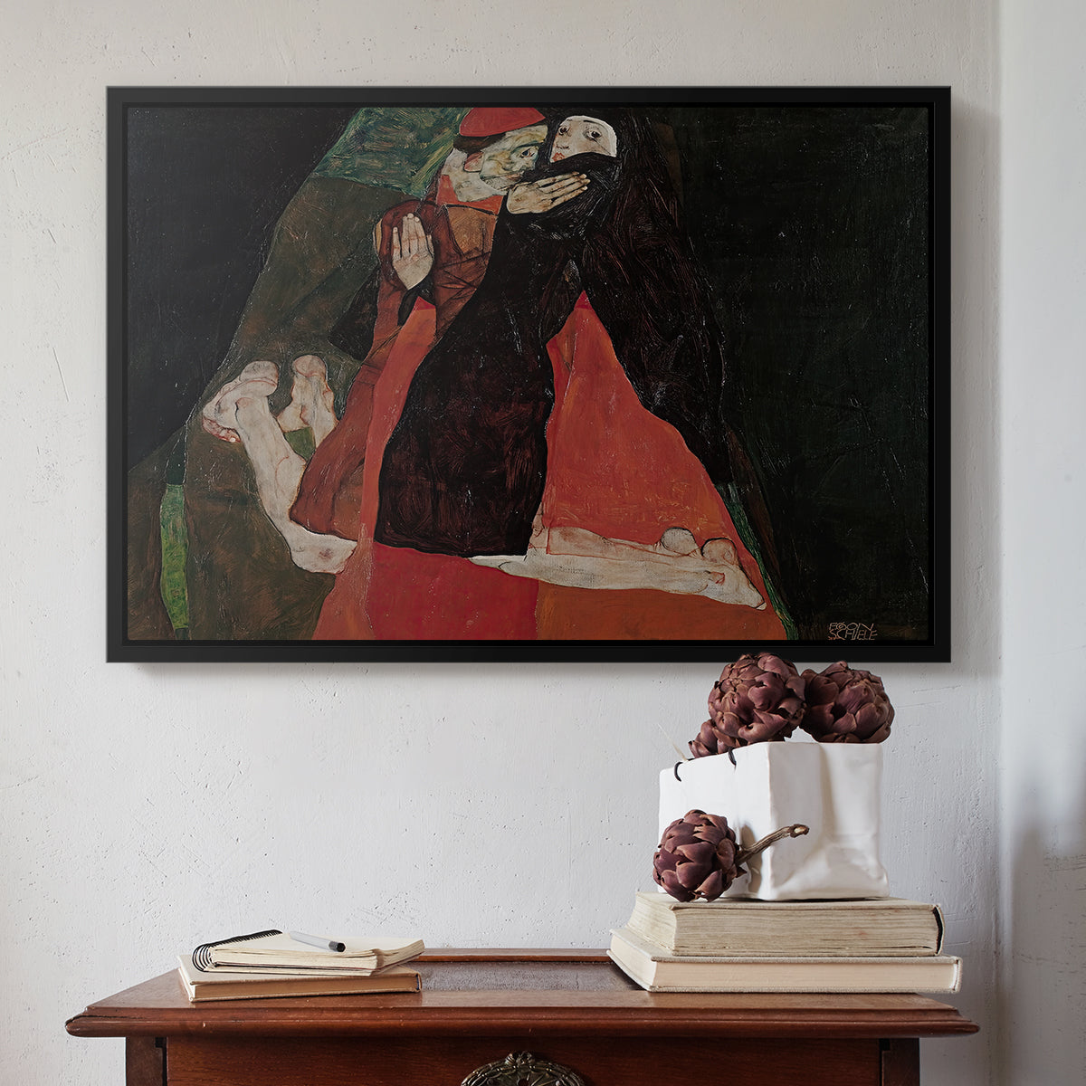Black floater framed canvas featuring Cardinal and Nun (Caress), 1912 by Egon Schiele above an entryway table in a minimalist foyer.