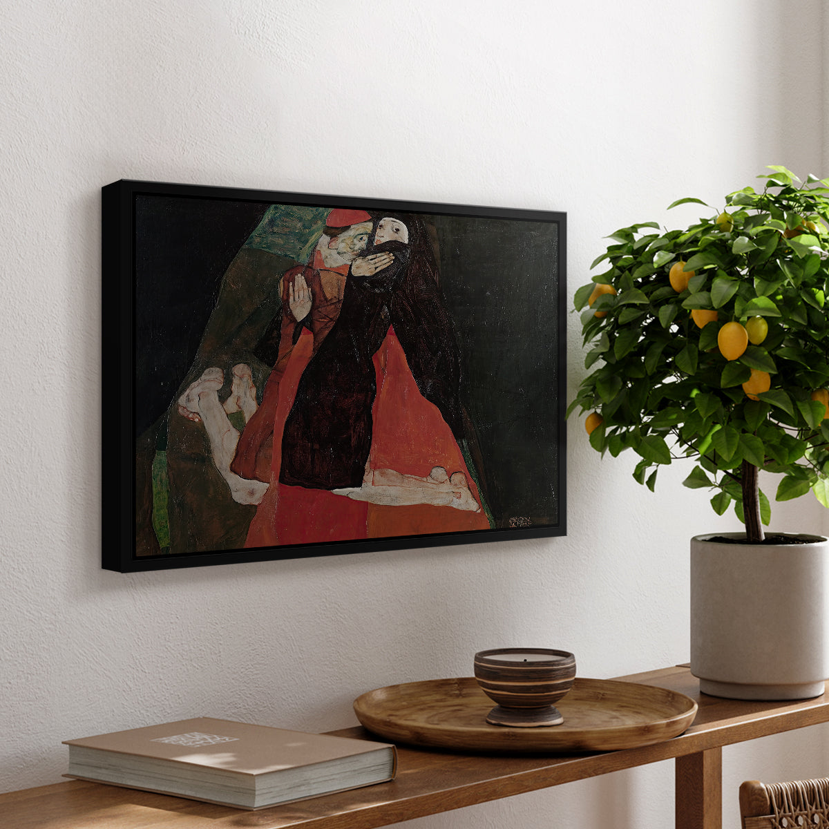 Cardinal and Nun (Caress), 1912 by Egon Schiele, presented in a black floater framed canvas featuring two figures embracing intimately in stylized expressionist composition, displayed above a hallway console table.