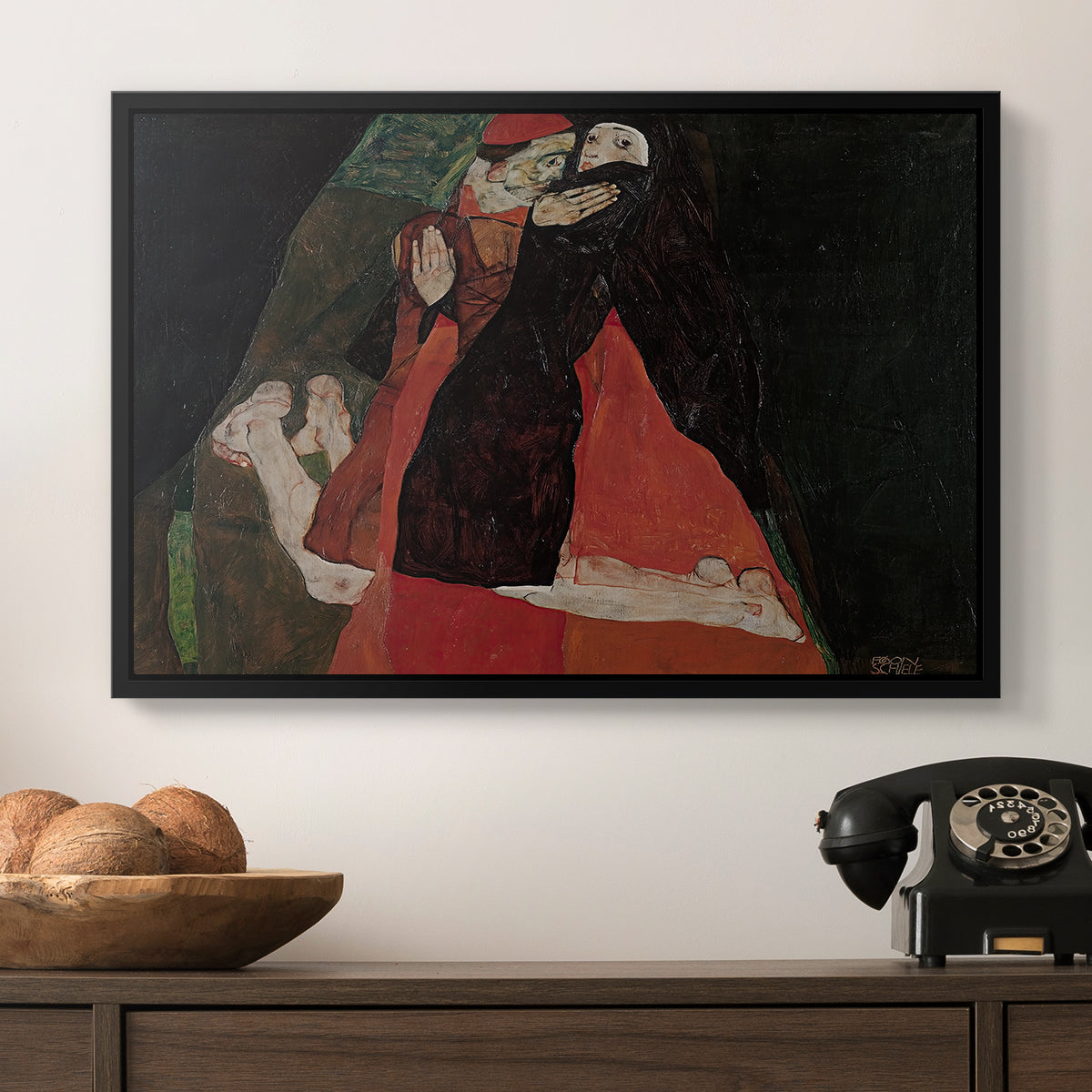 Cardinal and Nun (Caress), 1912 by Egon Schiele in a black floater framed canvas displayed above a console table in a hallway, featuring an intimate scene with religious figures in modernist style.