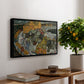 Crescent of Houses II (Island Town), 1915 by Egon Schiele, presented in a black floater framed canvas featuring a curved row of colorful houses forming crescent shape along water, displayed above a hallway console table.