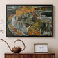Black floater framed canvas featuring an expressionist depiction of island town with geometric forms, displayed above a cabinet in a soft-toned living room.