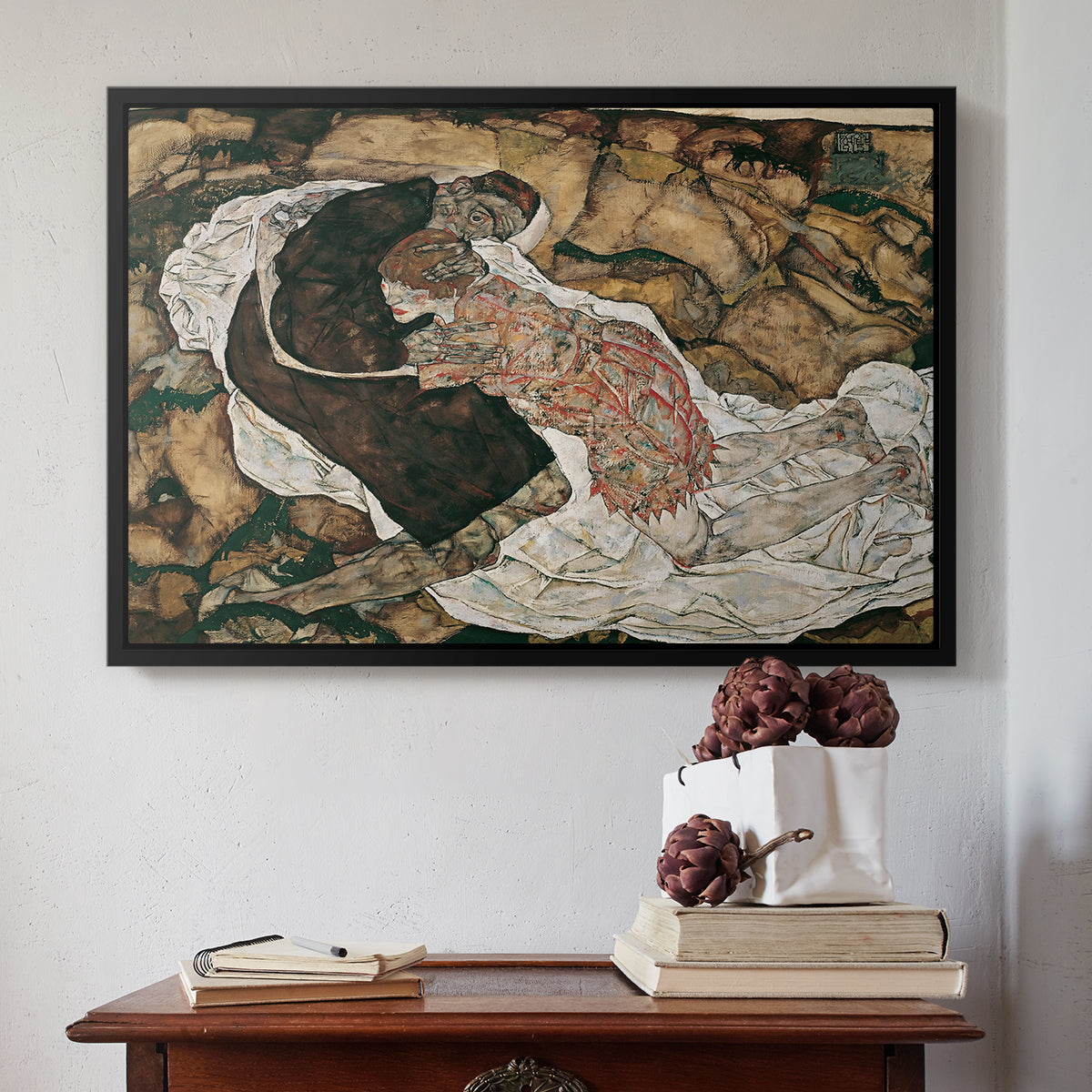 Black floater framed canvas featuring Death and the Maiden, 1915 by Egon Schiele above an entryway table in a minimalist foyer.