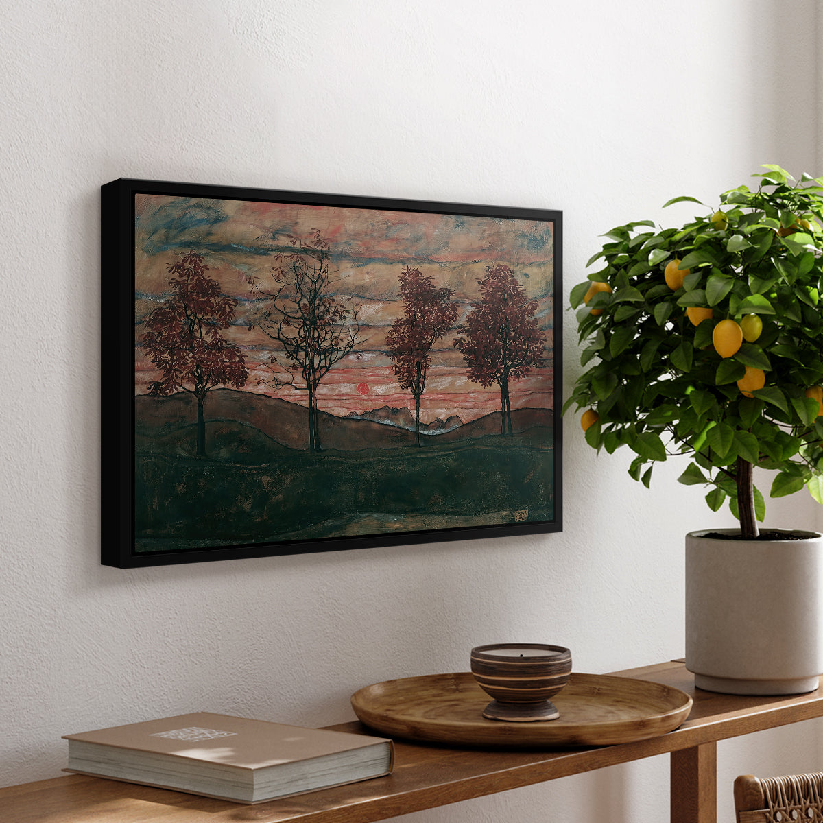 Four Trees, 1917 by Egon Schiele, presented in a black floater framed canvas featuring four trees standing in open landscape against colorful sky, displayed above a hallway console table.