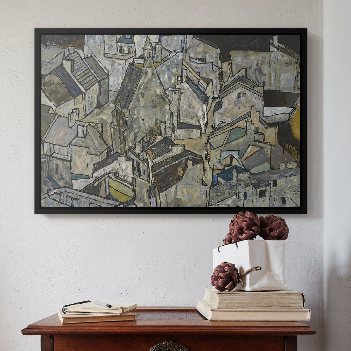 Black floater framed canvas featuring Mödling II, 1918 by Egon Schiele above an entryway table in a minimalist foyer.
