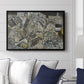 Mödling II, 1918 by Egon Schiele displayed above a sofa in a living room in a black floater frame, featuring an expressionist cityscape with tightly packed buildings and bold lines.